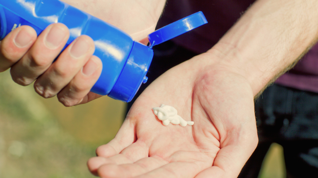 Person applying sunscreen to combat UV rays