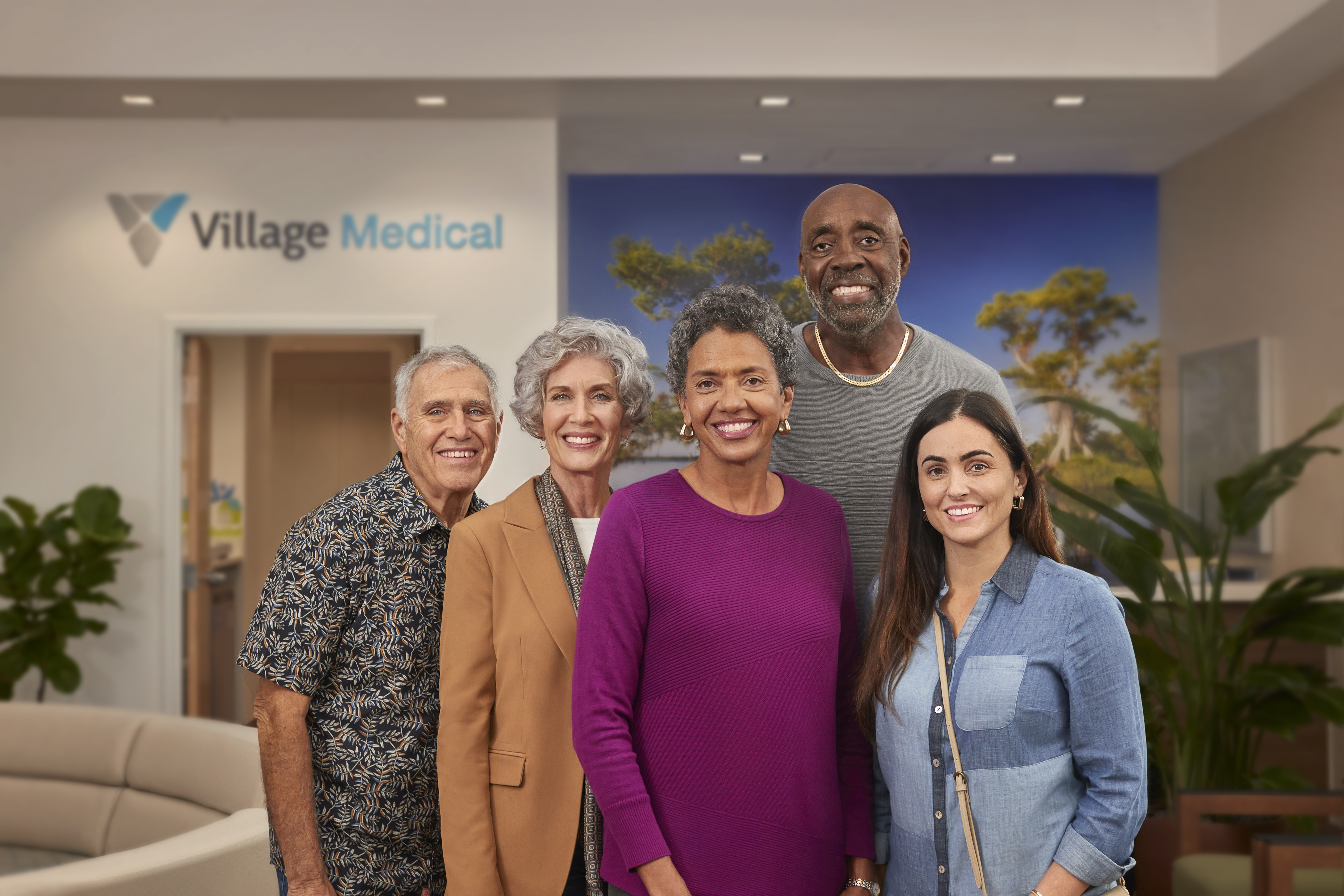 Group of diverse patients standing in a Village Medical location