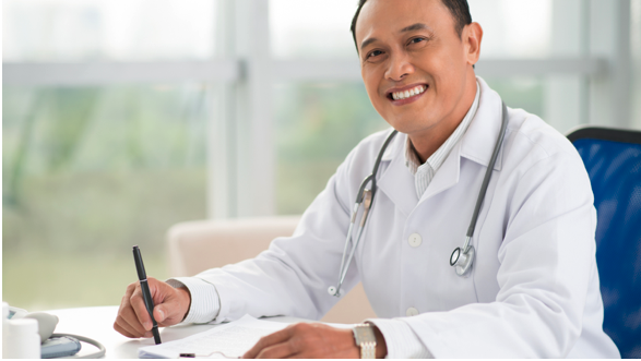 A Village Medical primary care doctor writing a specialist referral for a patient