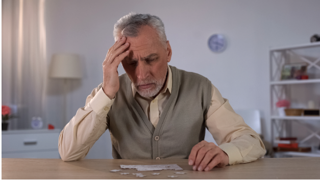 Man sitting at a table suffering from short-term memory loss