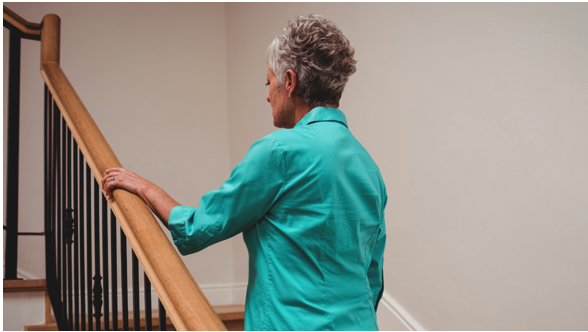 Senior woman climbing stairs safely