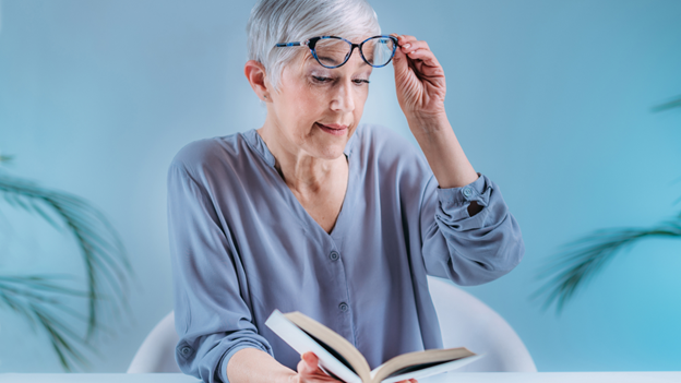 Woman with cataracts reading a book