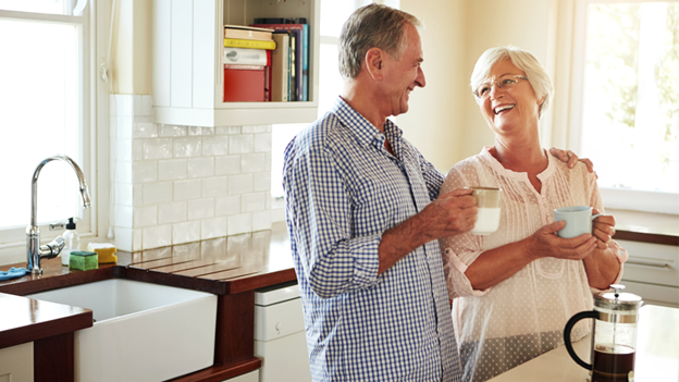 Two older adults with high blood pressure enjoying coffee in the kitchen