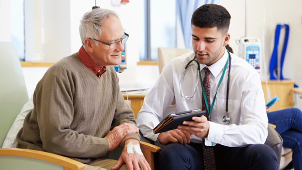 Doctor meeting with an elderly patient for value-based care at Village Medical